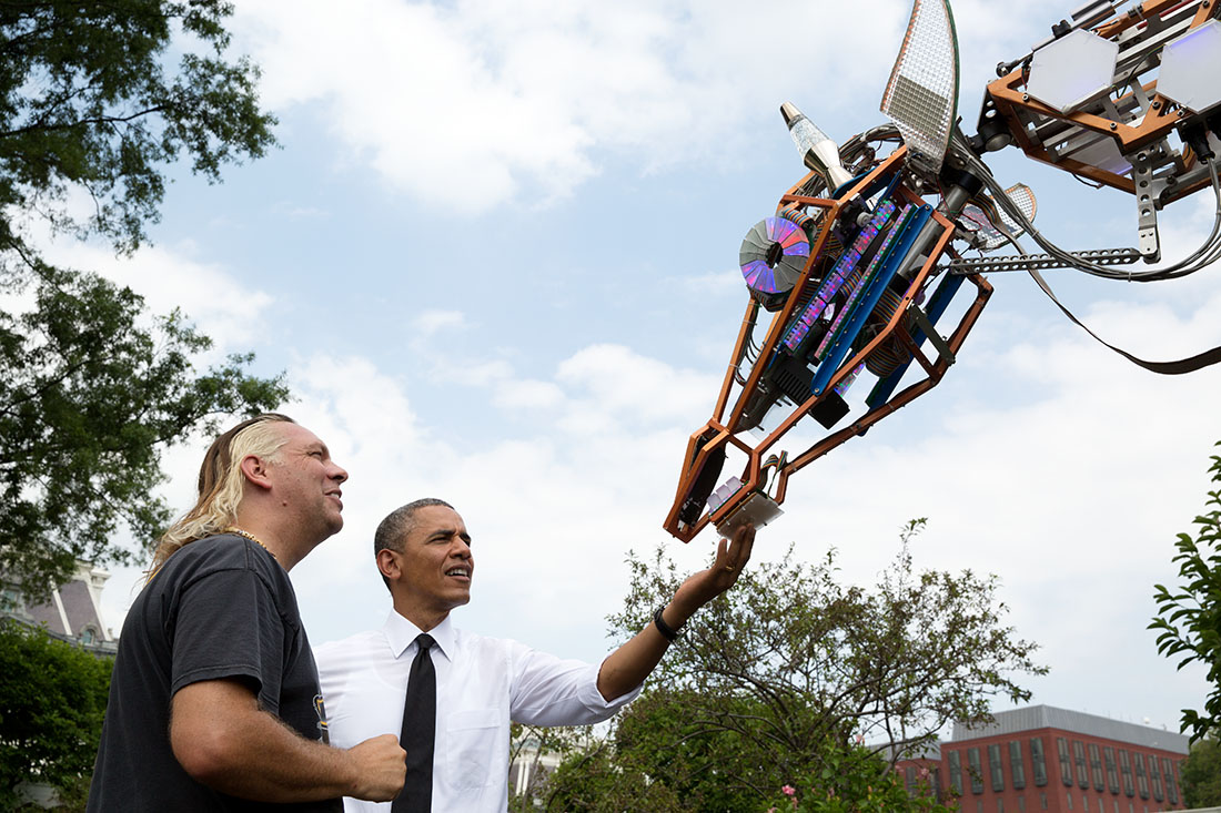 President Barack Obama looks at Lindsay Lawlor’s robotic giraffe on the South Lawn of the White House
